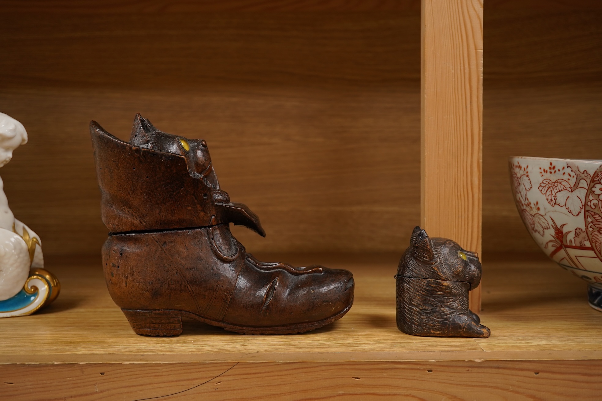 A Black Forest carving of a kitten in a boot inkwell and another car inkwell, tallest 15cm